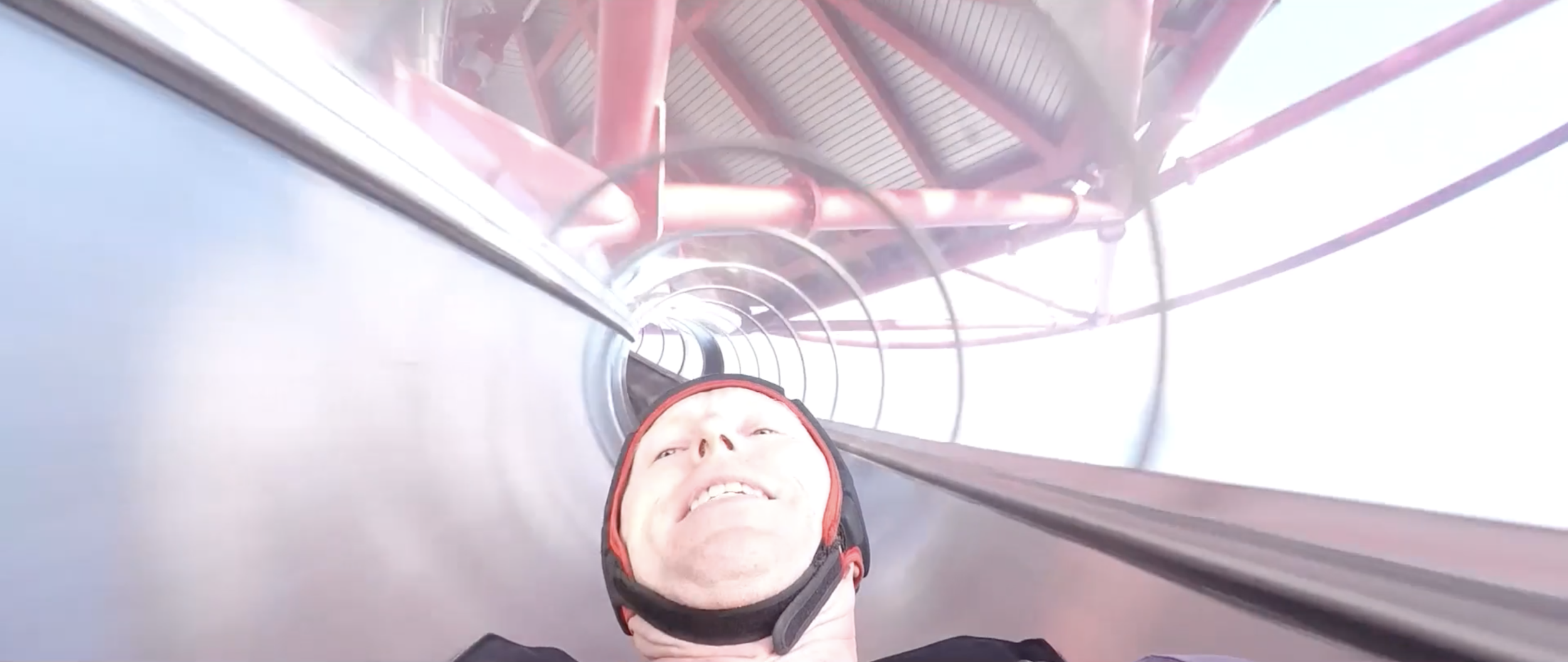 Head shot of man going down a flume