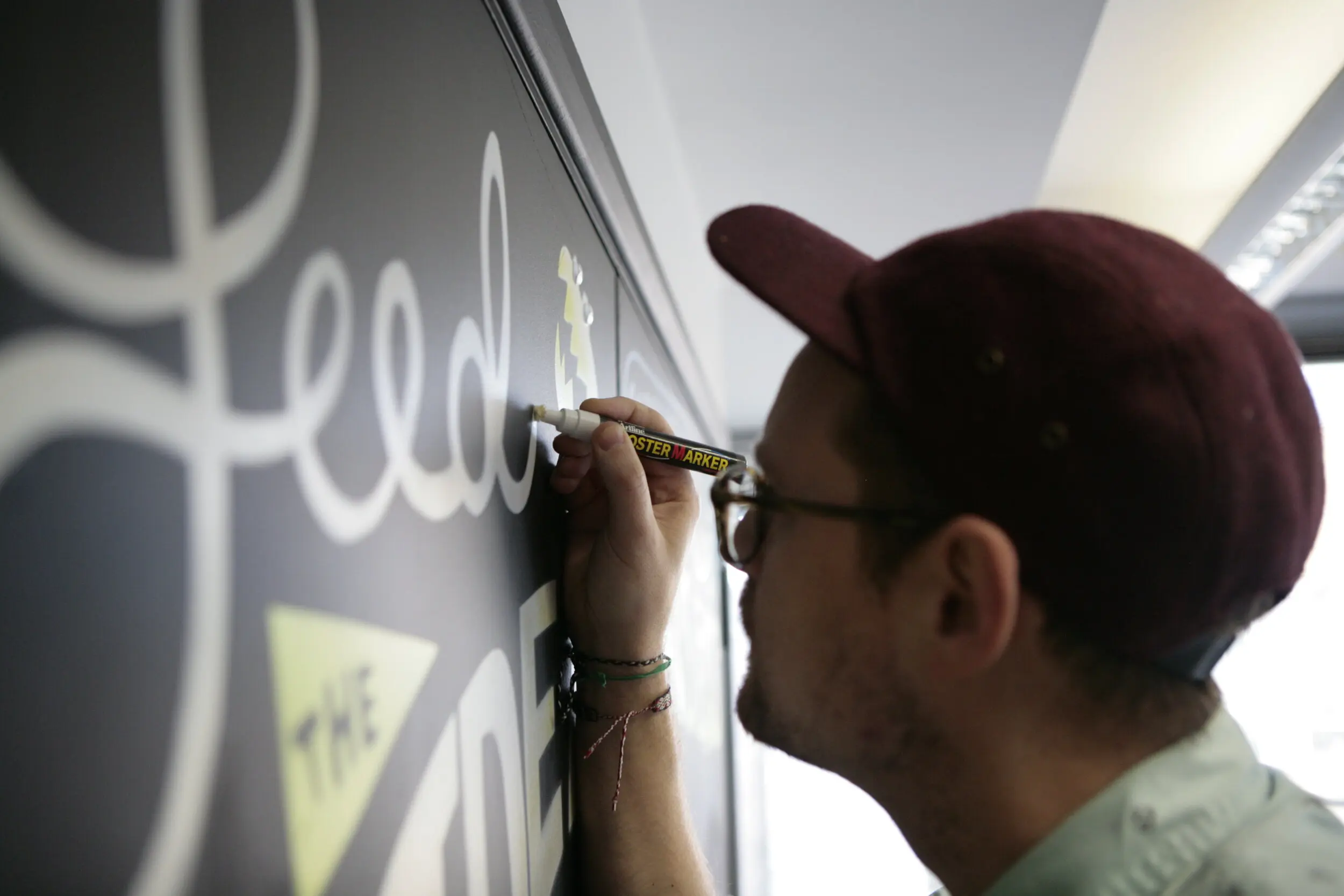 Man writing on a blackboard with a pen