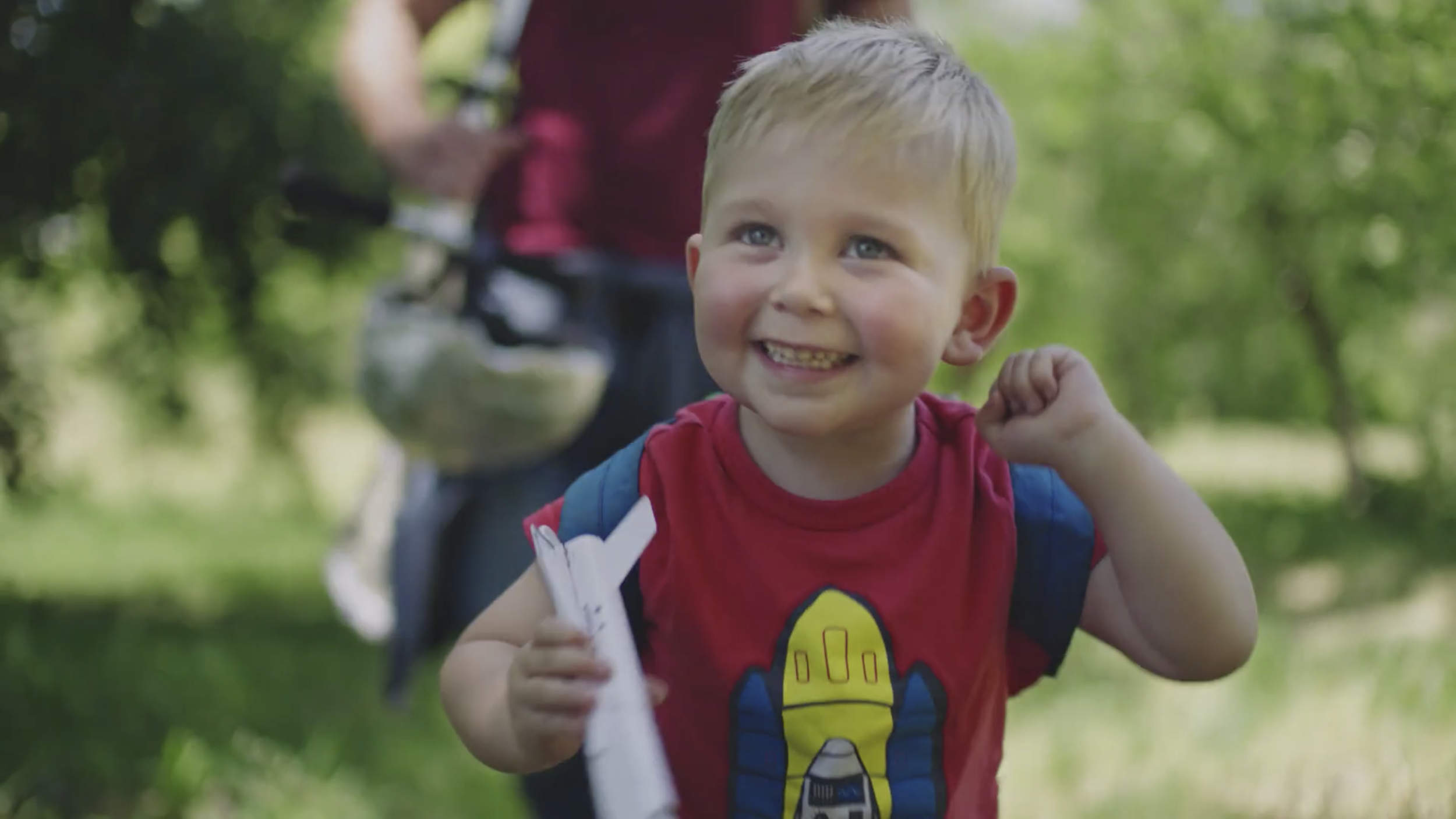 Little boy happily playing with his space rocket.