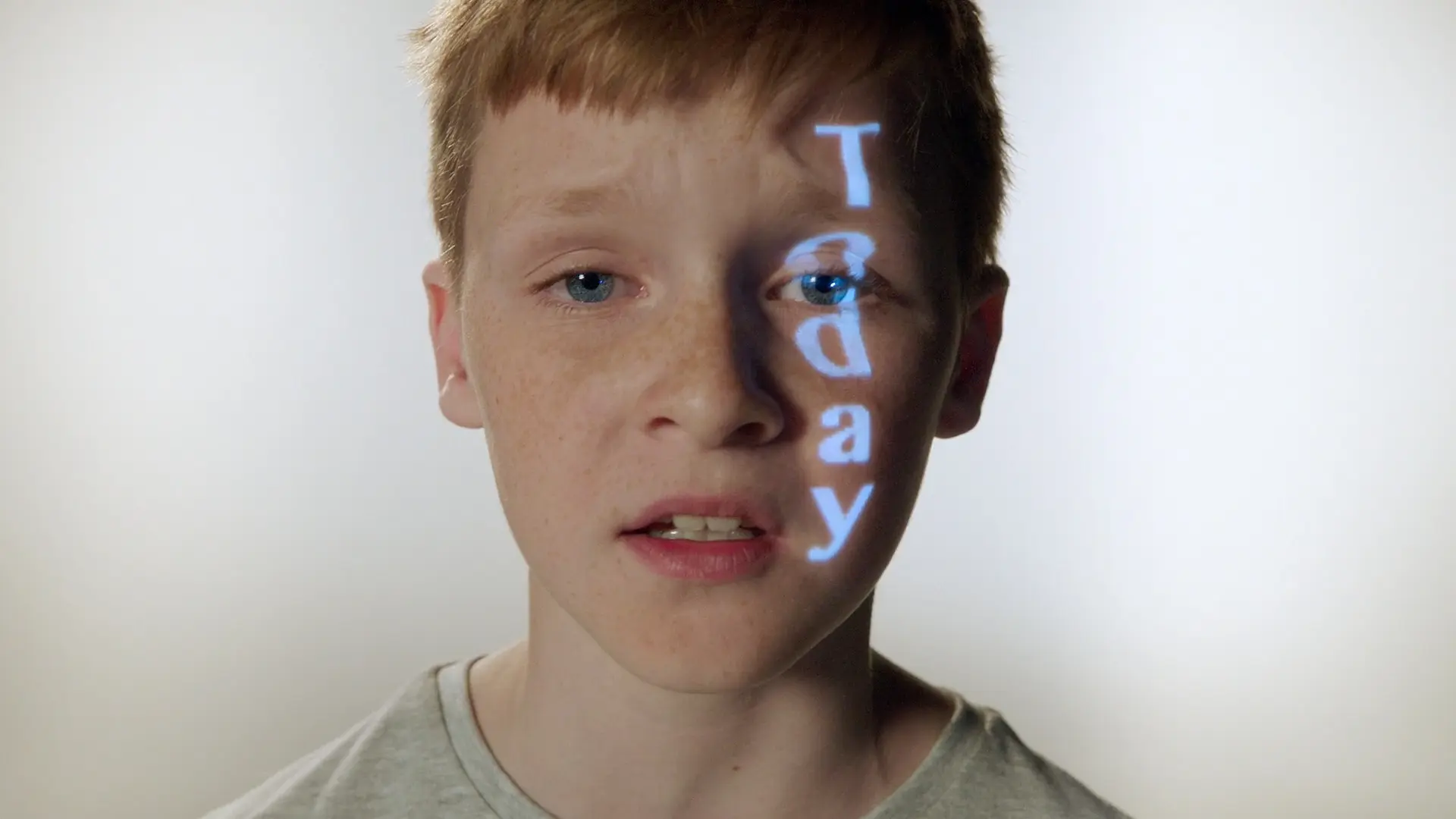 Young boy with the word Today projected onto his face