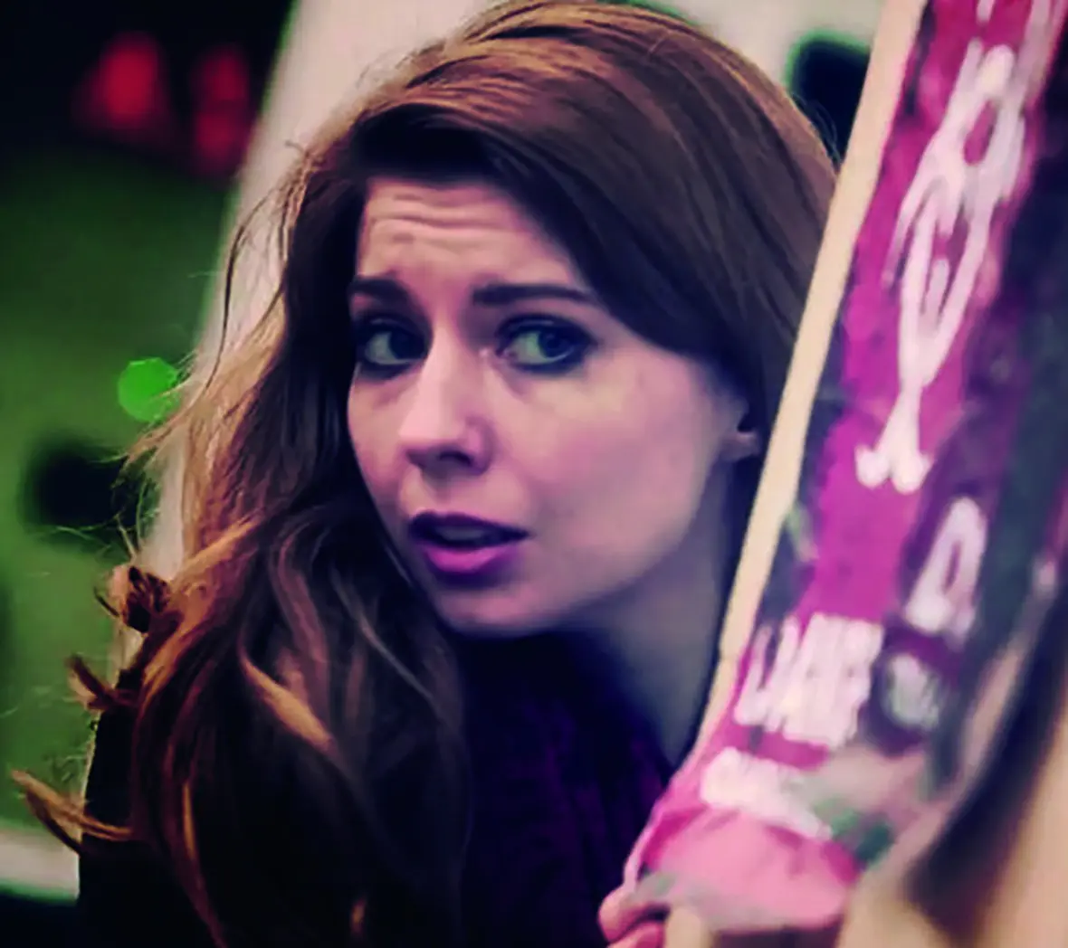 Scene from the Deadinburgh Event Promo video, shows woman hiding being a wall with a poster on it.