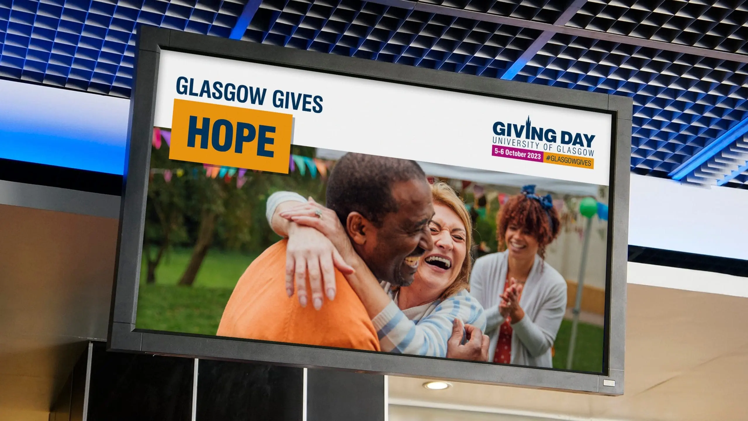 LCD TV showing 'Glasgow gives hope, Giving Day University of Glasgow' advertisement